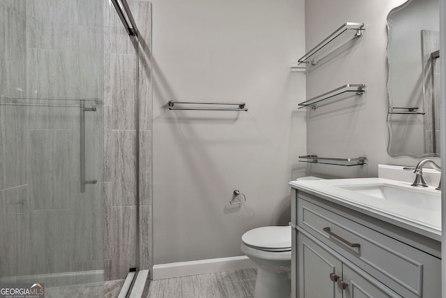 bathroom with walk in shower, toilet, hardwood / wood-style flooring, and vanity