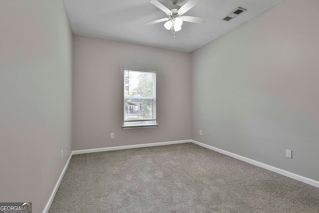 spare room featuring ceiling fan and carpet flooring