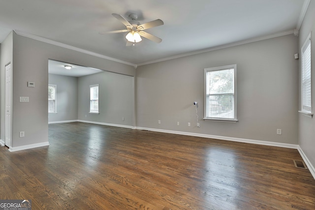 spare room featuring crown molding, dark hardwood / wood-style flooring, and ceiling fan