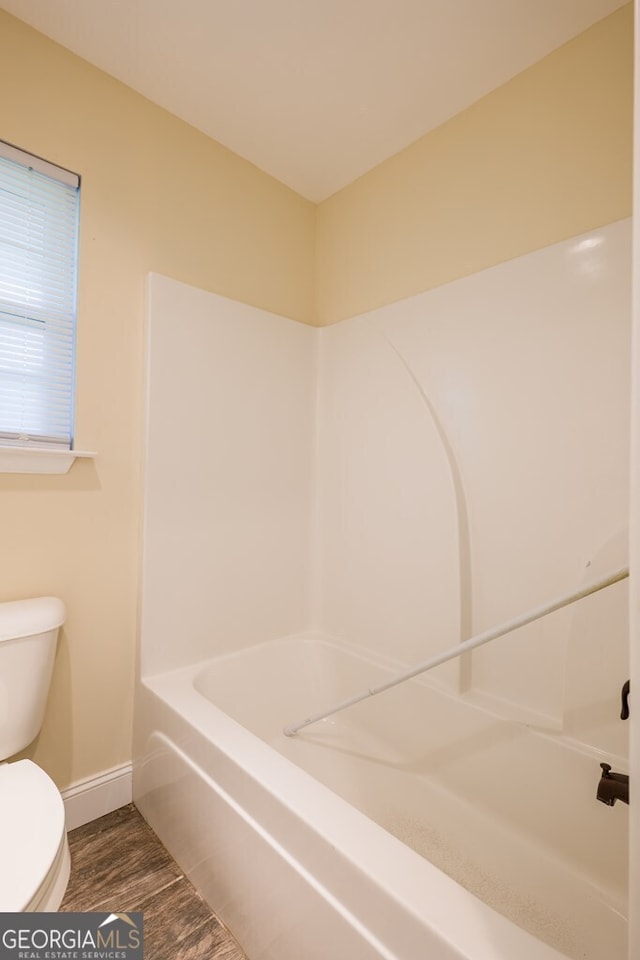 bathroom with toilet and wood-type flooring