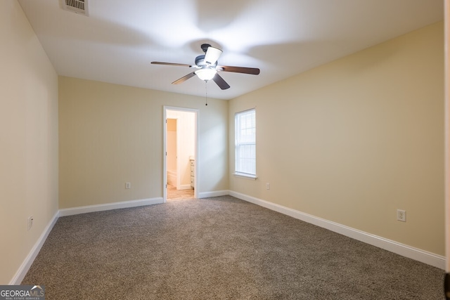 carpeted spare room with ceiling fan