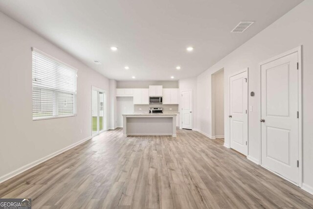 unfurnished living room featuring light wood-type flooring