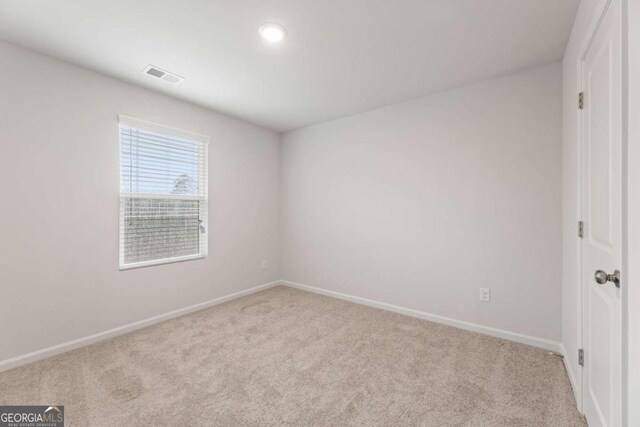 spare room with light carpet