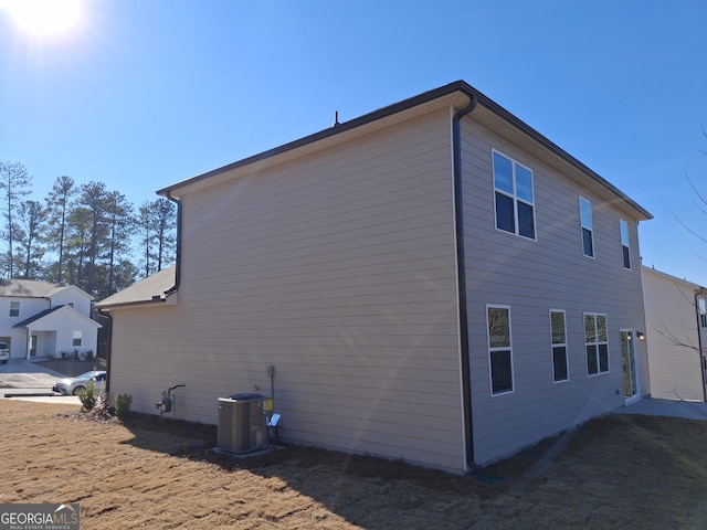 view of side of home featuring central AC