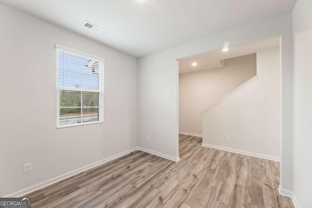 unfurnished room with light hardwood / wood-style floors