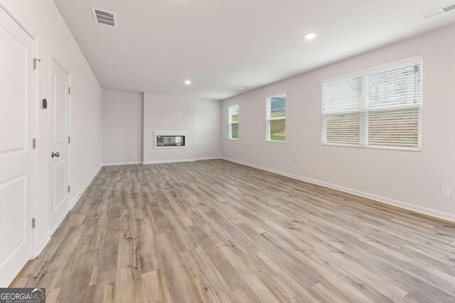 unfurnished living room with light wood-type flooring