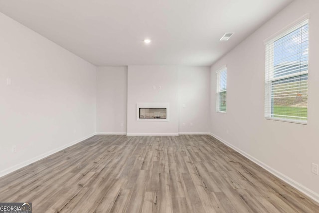 unfurnished living room with light hardwood / wood-style floors