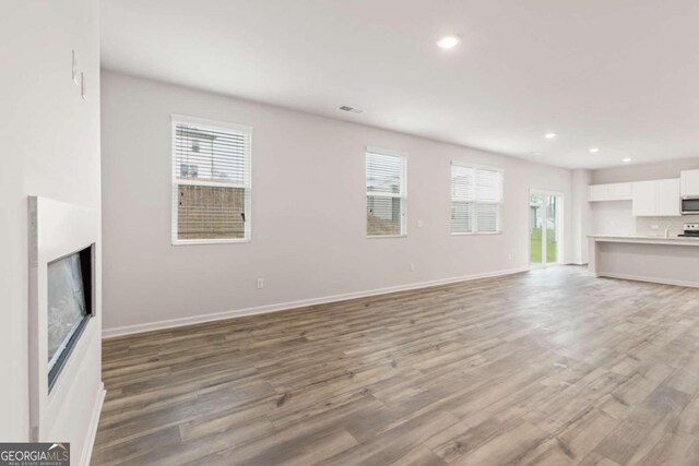 unfurnished living room with hardwood / wood-style floors