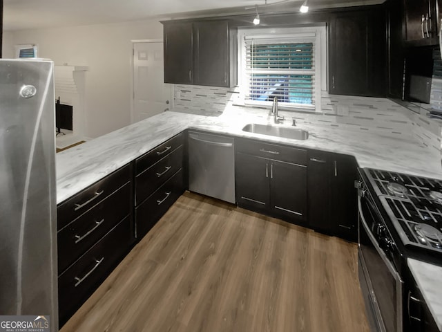 720 Smithstone Rd SE, Marietta, GA 30067 - kitchen with light stone counters, a sink, tasteful backsplash, wood finished floors, and appliances with stainless steel finishes