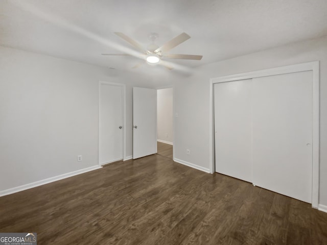 720 Smithstone Rd SE, Marietta, GA 30067 - unfurnished bedroom with a ceiling fan, a closet, baseboards, and dark wood finished floors
