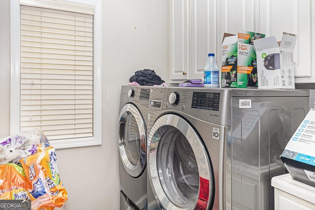 laundry room with cabinets and washing machine and dryer