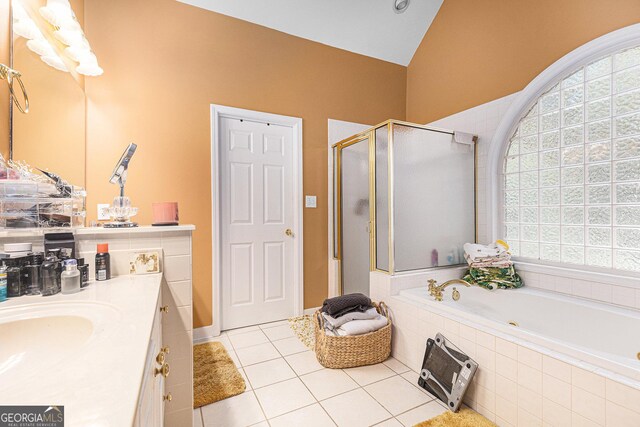 bathroom featuring lofted ceiling, tile patterned floors, independent shower and bath, and vanity