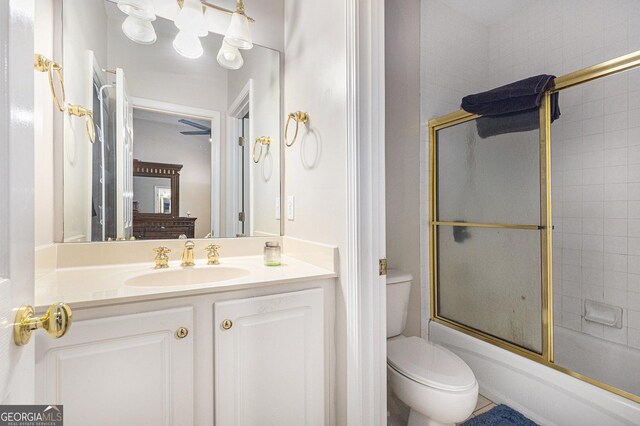 full bathroom with vanity, toilet, and bath / shower combo with glass door