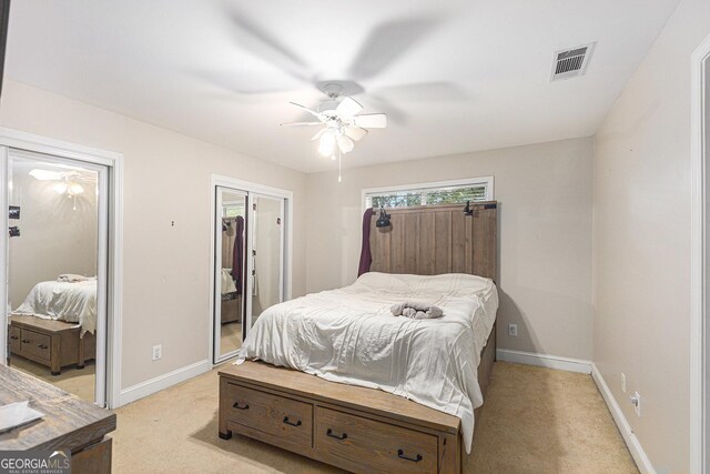 bedroom with light colored carpet and ceiling fan