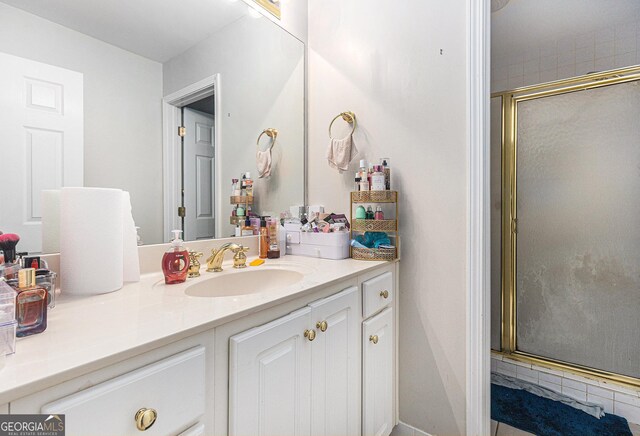 bathroom featuring vanity and a shower with door