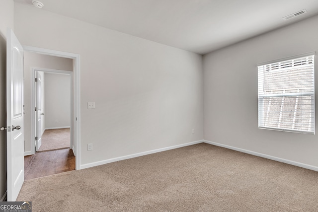 unfurnished room featuring carpet