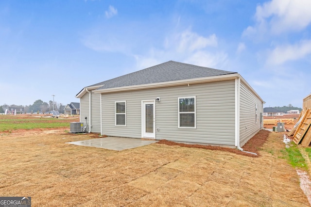 back of property featuring cooling unit, a lawn, and a patio area