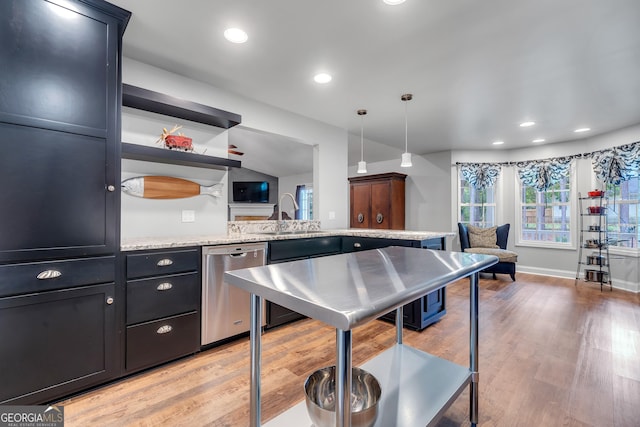 kitchen with hanging light fixtures, light wood-type flooring, a sink, and dishwasher