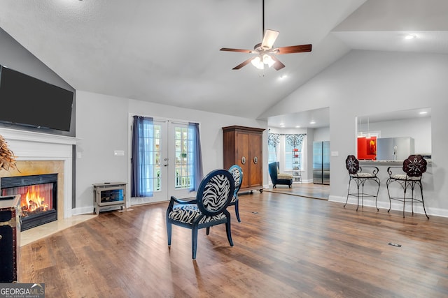 interior space featuring a wealth of natural light, light wood-style flooring, and a tile fireplace