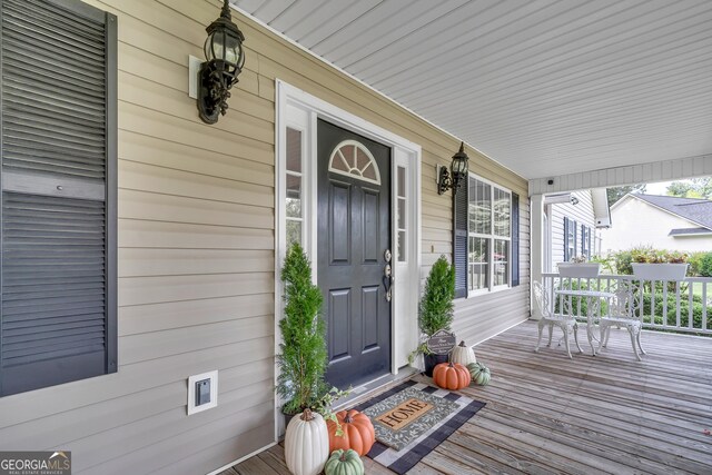 view of exterior entry featuring a porch