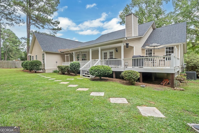 back of property featuring a shingled roof, a lawn, a chimney, cooling unit, and french doors