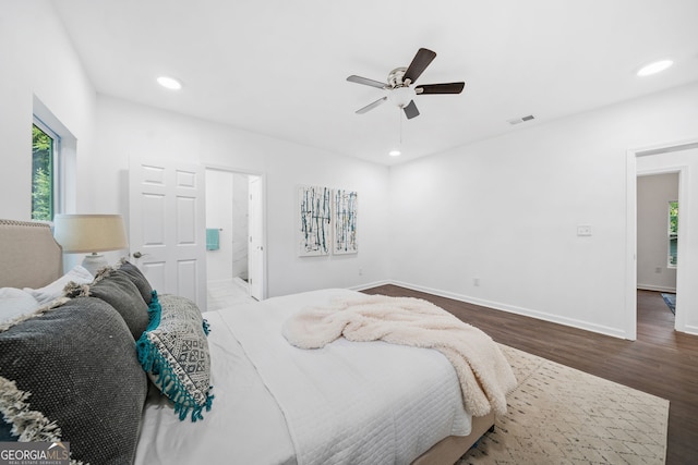 bedroom with wood-type flooring, ensuite bathroom, and ceiling fan