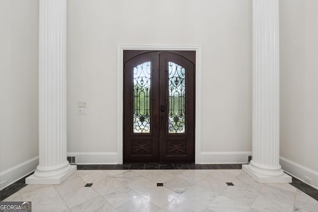 entrance foyer with ornate columns and french doors