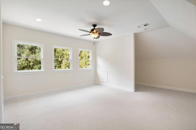 interior space featuring light carpet, ceiling fan, and lofted ceiling