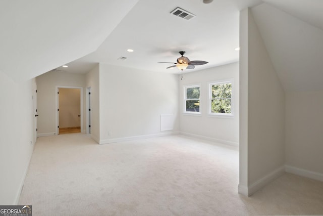 bonus room featuring light carpet, vaulted ceiling, and ceiling fan