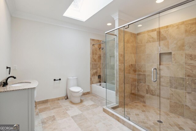 bathroom with vanity, toilet, ornamental molding, and a skylight