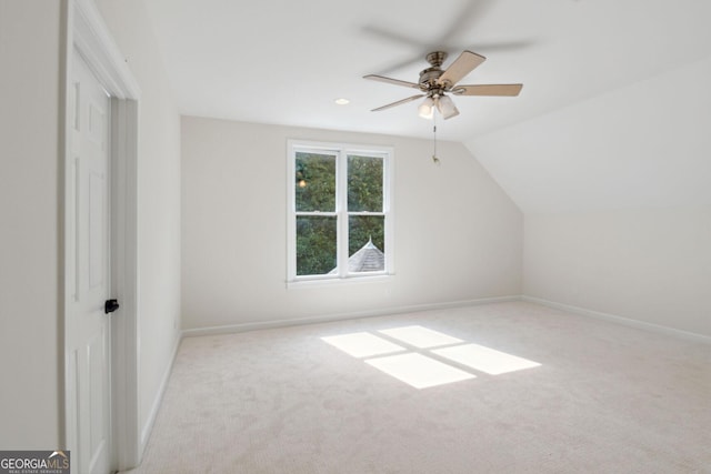 additional living space with ceiling fan, light carpet, and vaulted ceiling