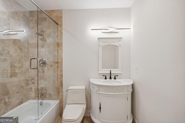 full bathroom featuring vanity, toilet, and bath / shower combo with glass door