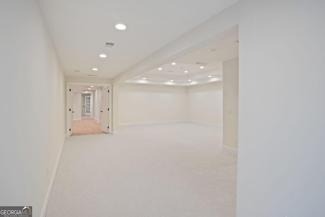 basement featuring light colored carpet