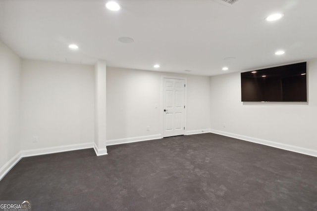 basement featuring dark colored carpet