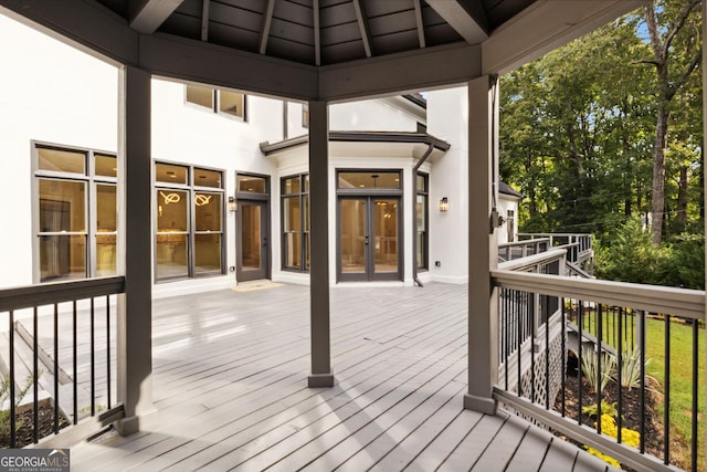 wooden deck with a gazebo and french doors