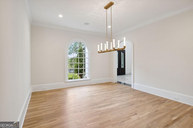 unfurnished dining area with light wood-type flooring and ornamental molding