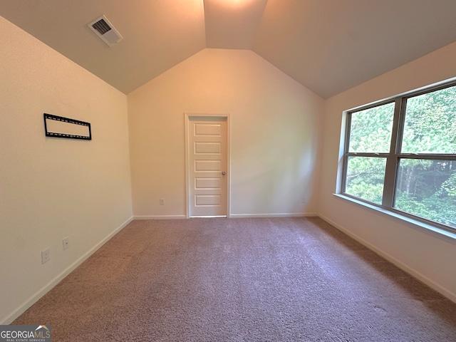 unfurnished bedroom with lofted ceiling and carpet floors