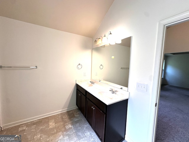 bathroom featuring lofted ceiling and vanity