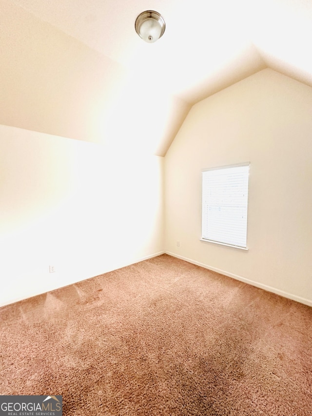 bonus room featuring lofted ceiling and carpet flooring