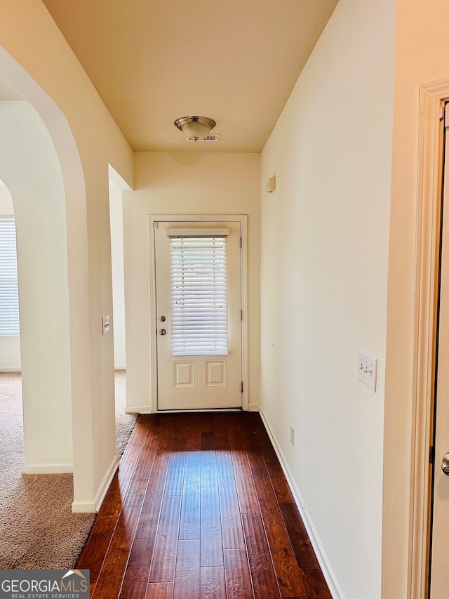 doorway featuring dark wood-type flooring