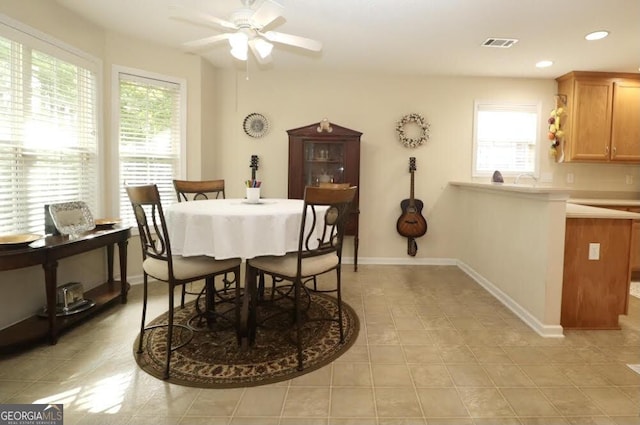 dining area featuring a healthy amount of sunlight, baseboards, visible vents, and a ceiling fan