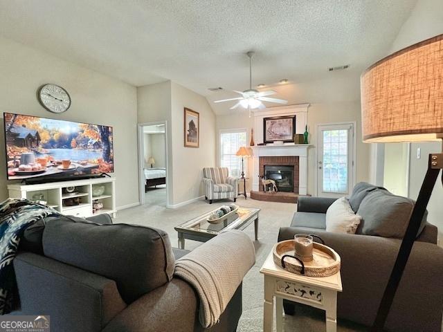 living room featuring carpet flooring, plenty of natural light, and a textured ceiling