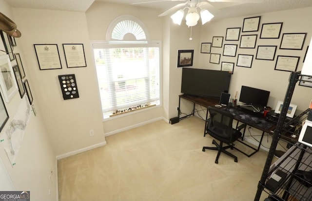 office area with carpet, baseboards, and a ceiling fan