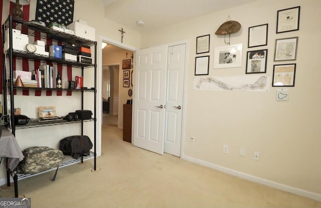 interior space with carpet floors and baseboards