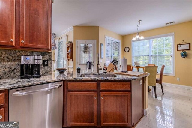 kitchen featuring stone counters, a chandelier, sink, tasteful backsplash, and stainless steel dishwasher