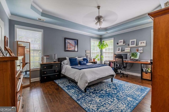 bedroom featuring multiple windows, ceiling fan, and dark hardwood / wood-style flooring