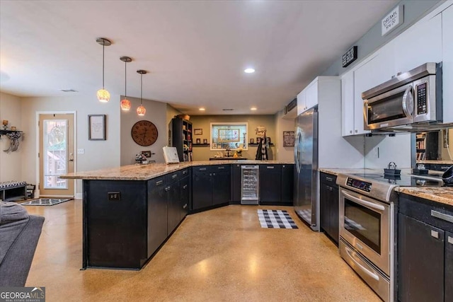 kitchen with pendant lighting, white cabinetry, beverage cooler, kitchen peninsula, and appliances with stainless steel finishes