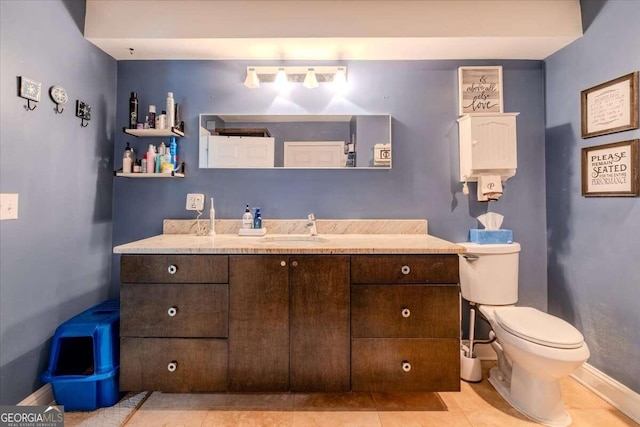 bathroom with tile patterned floors, toilet, and vanity