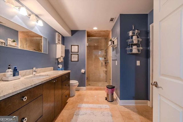 bathroom with vanity, toilet, an enclosed shower, and tile patterned floors