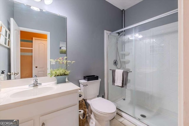 bathroom with vanity, toilet, walk in shower, and tile patterned floors